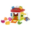 A colorful toy house with various shape blocks and animal figures scattered around it on a white background. Produktbild-Vorschau