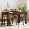 A dining table with chairs, set in a room with plants and artwork. Podgląd zdjęcia produktu