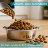 Dog food being poured into a metal bowl. Produktbild-Vorschau