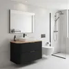 A modern bathroom with a black vanity, white sink, and a walk-in shower. Produktbild-Vorschau