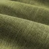 A close-up, textured view of green fabric, showing the weave and folds. Produktbild-Vorschau