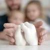 A family's hands holding a 3D hand cast sculpture. Náhled obrázku produktu
