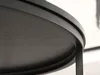 A close-up, low-angle shot of the edge and surface of a dark-colored round table. Podgląd zdjęcia produktu