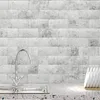 Silver kitchen faucet with two handles over a double stainless steel sink, against a white tiled backsplash Produktbild-Vorschau