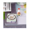A miniature dollhouse scene with a milk bottle and a food bowl for a kitten. Anteprima dell’immagine prodotto