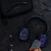 A flat lay of an Astro gaming headset and accessories on a dark textured surface. Anteprima dell’immagine prodotto