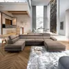A spacious, modern living room with a large sectional sofa, dining area, and kitchen in the background. Produktbild-Vorschau