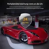 A red sports car parked in a dimly lit parking garage, with a shield graphic overlaid on the front of the car. Produktbild-Vorschau