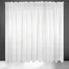 A white sheer curtain hanging against a dark gray wall and a white floor. Produktbild-Vorschau