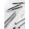 Several drawing instruments, including pens and rulers, are laid out on a white surface. Anteprima dell’immagine prodotto