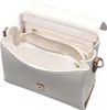 An open white handbag with tan accents, showing its interior compartments. Náhľad obrázku produktu
