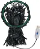 A bundle of black LED string lights coiled within a green hoop, with a USB connector visible. Podgląd zdjęcia produktu