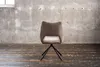 A chair in an empty room with a concrete wall and wooden floor. Produktbild-Vorschau