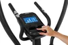 A close-up of a person's hand interacting with the control panel of an exercise machine. Anteprima dell’immagine prodotto