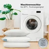A washing machine and pillows are shown in a domestic setting, with text indicating the pillows are machine washable. Produktbild-Vorschau