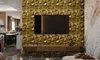 A modern living room with a TV mounted on a textured gold wall, a wooden media console below, and a dining area in the background. Anteprima dell’immagine prodotto