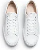 A top-down view of a pair of white leather sneakers. Produktbild-Vorschau
