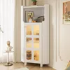 A white corner cabinet with glass doors and LED lighting is shown in a room setting. Produktbild-Vorschau