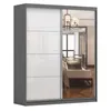 A modern sliding door wardrobe with a gray frame and white panels, one of which is a mirror reflecting a living room interior. Produktbild-Vorschau