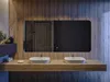 A modern bathroom vanity with two sinks and a large illuminated mirror. Produktbild-Vorschau