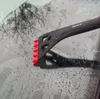 A close-up of an ice scraper being used on a wet car windshield. Anteprima dell’immagine prodotto