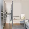 A TV wall mount is installed on a wall, holding a TV, in a modern living room setting. Anteprima dell’immagine prodotto