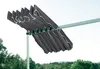 A gray awning is extended outdoors, with trees and hills in the background. Produktbild-Vorschau