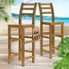 Two wooden bar stools are placed on a deck overlooking a beach and ocean. Anteprima dell’immagine prodotto