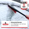 A hand is using a snow brush to clear snow from a car windshield. Náhľad obrázku produktu