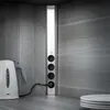 A close-up view of a power strip with multiple outlets, plugged into a wall socket, with a white electric kettle next to it. Náhled obrázku produktu