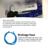 A person is cleaning an air conditioner with a blue cover and a drainage hose. Náhled obrázku produktu