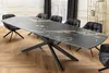 A dining room setting with a large extendable table and chairs. Produktbild-Vorschau