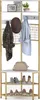 A corner coat rack with shelves and hooks, displaying clothing, a hat, a purse, and shoes. Podgląd zdjęcia produktu