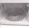 Interior of a microwave oven with a wire rack placed on the glass turntable. Náhľad obrázku produktu