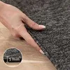 A hand is shown pressing down on a carpet, with a close-up inset showing the carpet's thickness. Náhled obrázku produktu