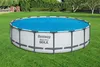 An above-ground swimming pool is set up on a green lawn, surrounded by trees and bushes. Produktbild-Vorschau