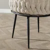 A close-up view of the legs and woven seat of a chair. Produktbild-Vorschau