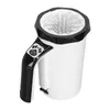 A white and black automatic dog paw cleaner with a handle and a power button with a paw print icon. Náhľad obrázku produktu