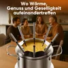 People gathered around a fondue pot on a table. Voir les images du produit