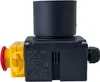 A close-up studio shot of a black electrical switch with yellow and red components attached, set against a white background. Produktbild-Vorschau