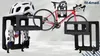 A bicycle and cycling accessories are displayed on black stands against a light gray and white background. Náhled obrázku produktu