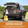 A dog in a crate in the back of a car, with a guitar and a beach chair nearby. Podgląd zdjęcia produktu