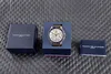 A Tommy Hilfiger watch is displayed with its packaging and manual on a textured gray surface. Anteprima dell’immagine prodotto
