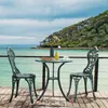 A bistro set with two chairs and a table on a wooden deck overlooking the ocean. Produktbild-Vorschau