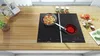 A kitchen countertop with a stovetop, food, and cooking utensils. Produktbild-Vorschau