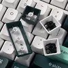 A close-up view of disassembled mechanical keyboard keycaps and switches. Voir les images du produit