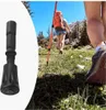 A collage showing a close-up of a black trekking pole tip on the left, and a person hiking with trekking poles in a mountainous landscape on the right. Náhled obrázku produktu