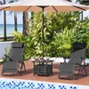 Two black lounge chairs and a small table are set up on a wooden deck next to a swimming pool, with lush greenery and palm trees in the background. Produktbild-Vorschau