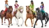 Four toy horses with riders, posed in a line against a white background. Náhľad obrázku produktu