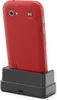 A red smartphone is docked in a black charging cradle. Produktbild-Vorschau